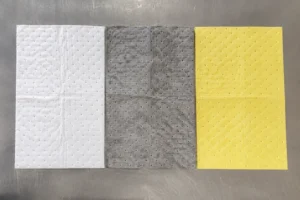 White, grey, and yellow oil absorbent pads-compressed