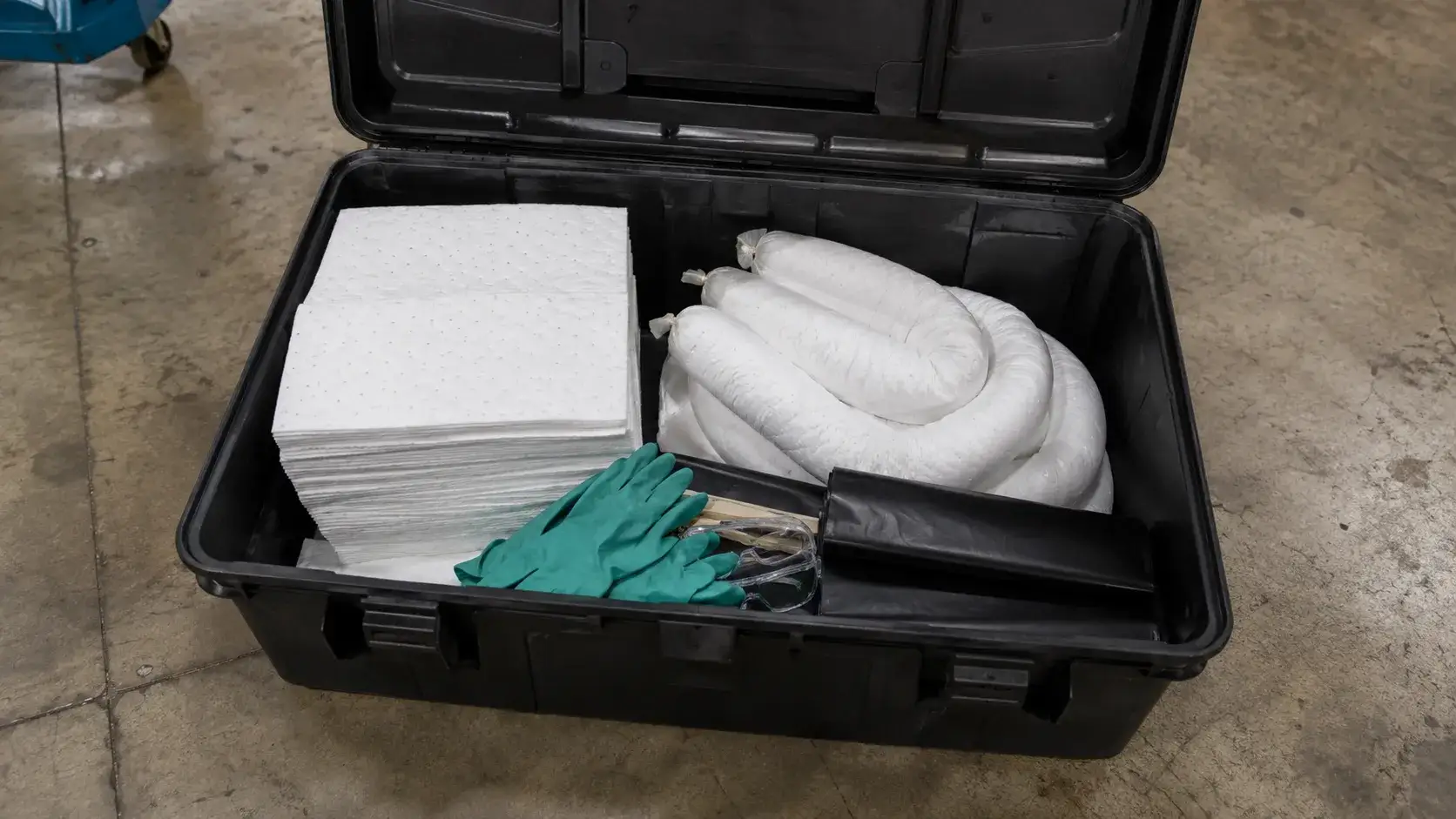 Open oil spill kit containing-compressed