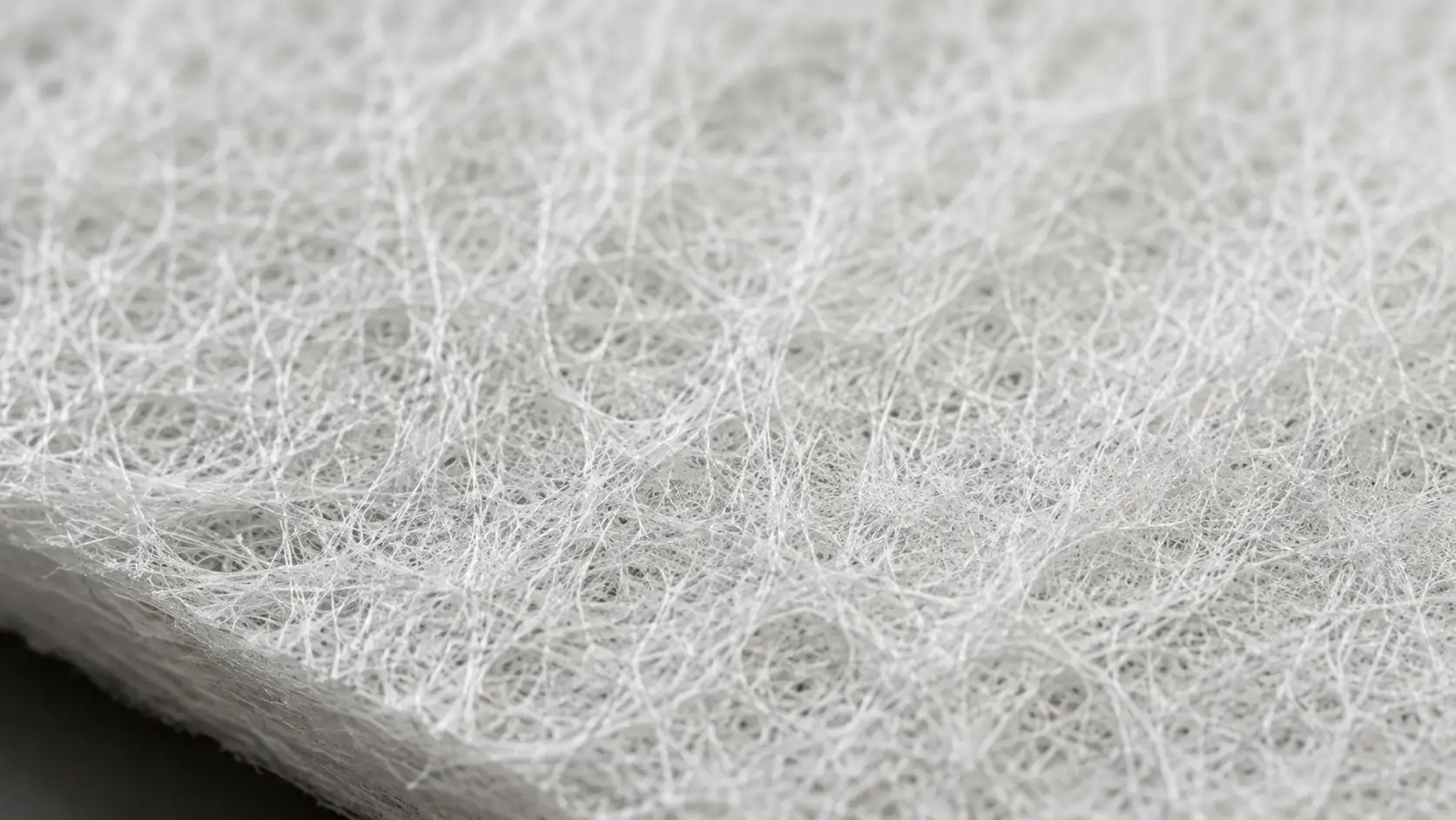 Macro view of white meltblown polypropylene fibers used in oil absorbent pads